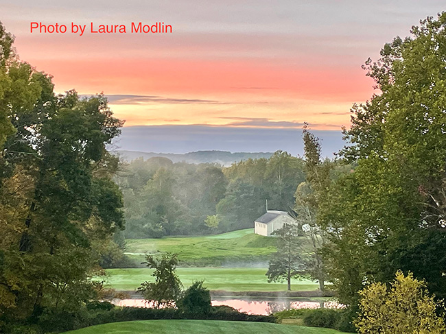 photo of clouds over a cottage in the fields