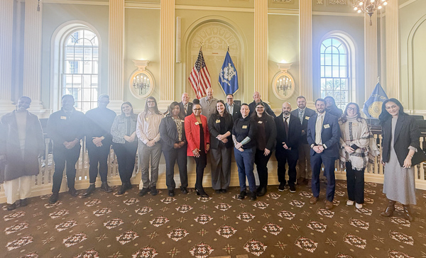 a group of people posing for a photo in a town hall