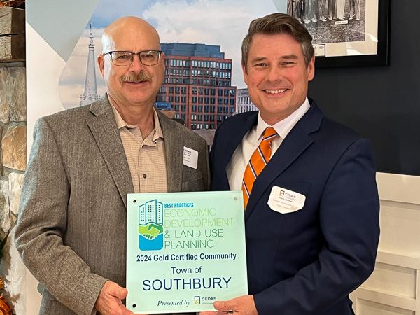 first selectman and economic development director holding an award