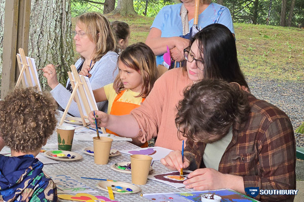 adults and children painting at the table
