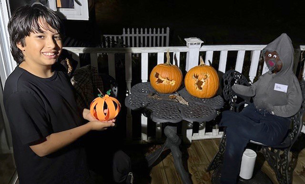 child with craft and scarecrows