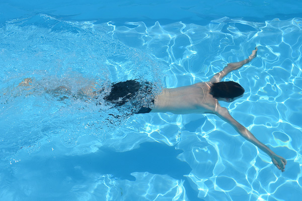 person swimming in a pool