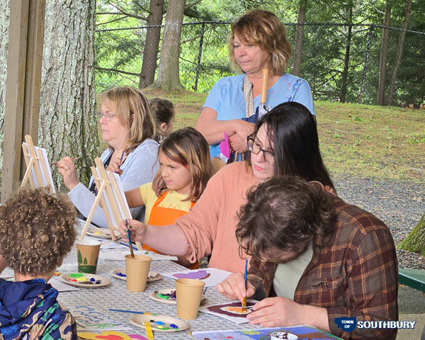 adults and children painting