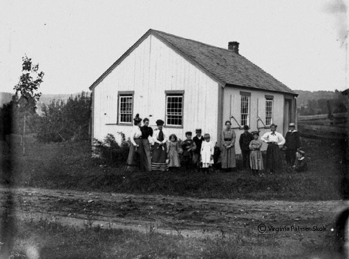 Women and children in front of old house in Southbury